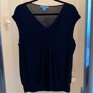 Black V-neck top with cap sleeves.